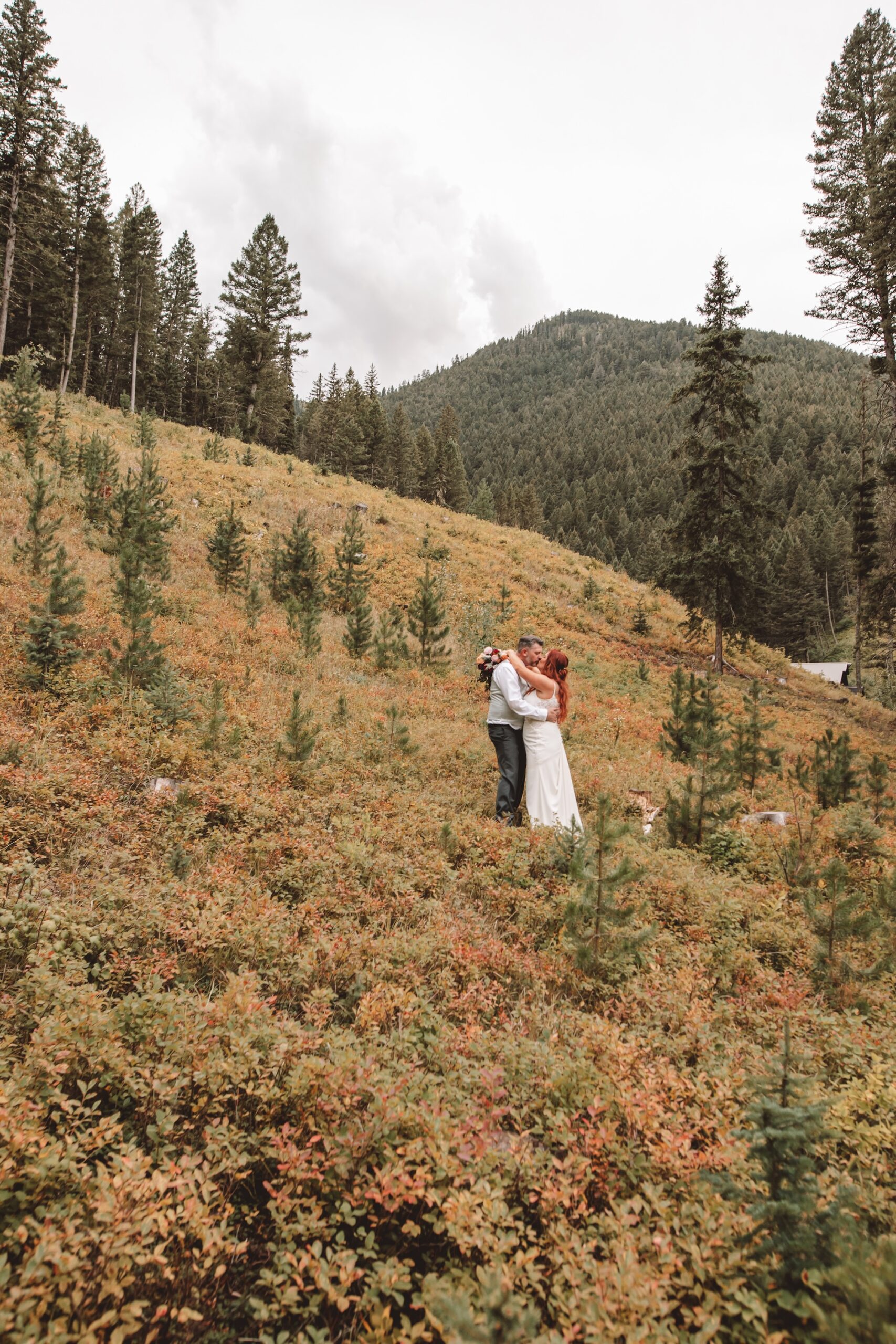 Bride and groom in the mountains of montana with their wedding florals