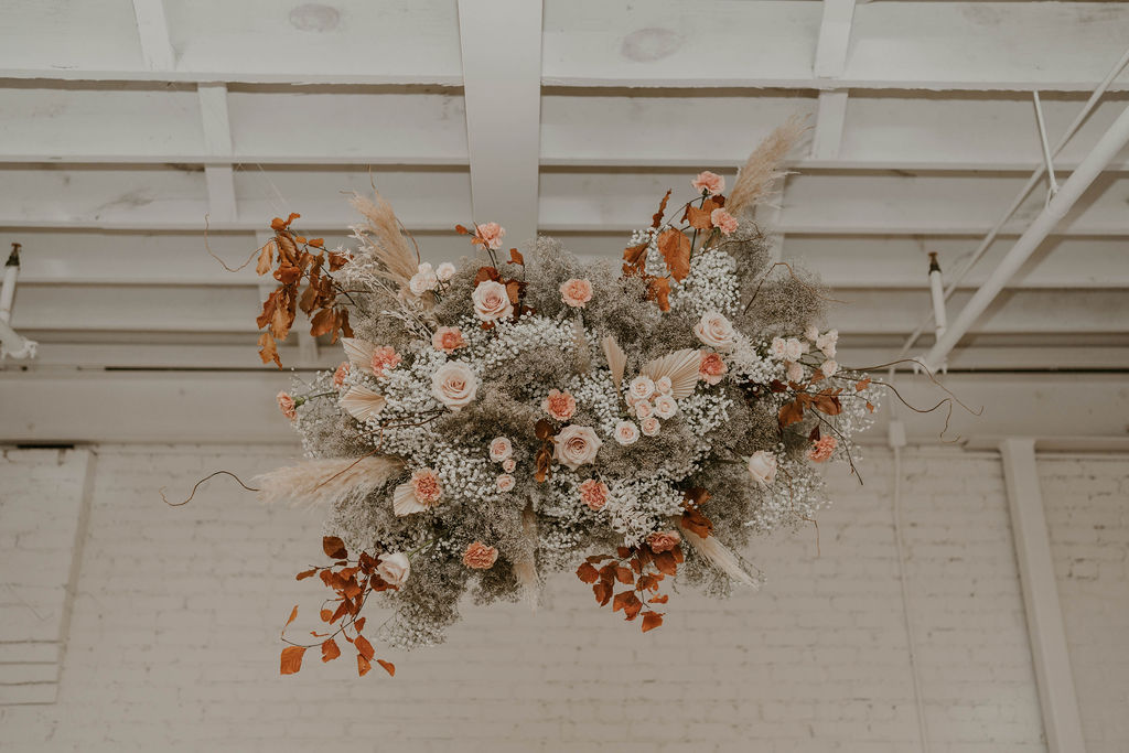 A hanging wedding floral design installation by a full service wedding florist